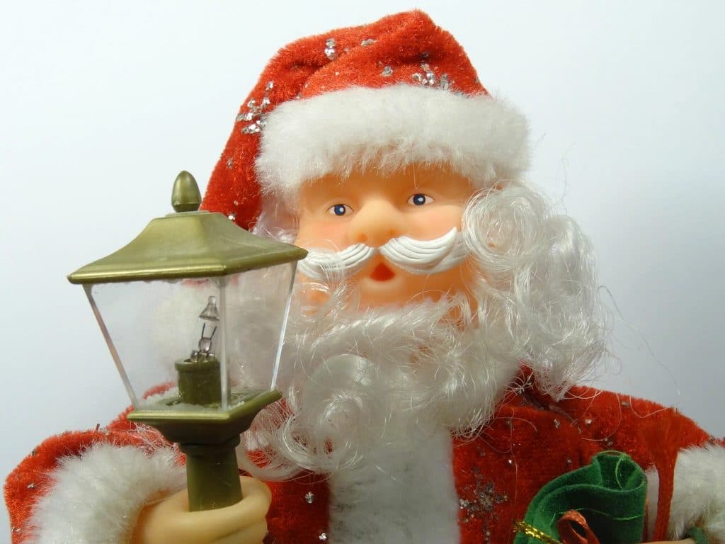 A Santa Claus figurine holding a lantern