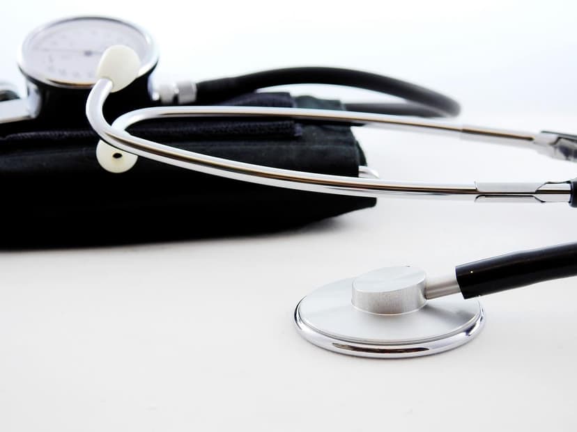 A stethoscope and a blood pressure cuff on a white surface
