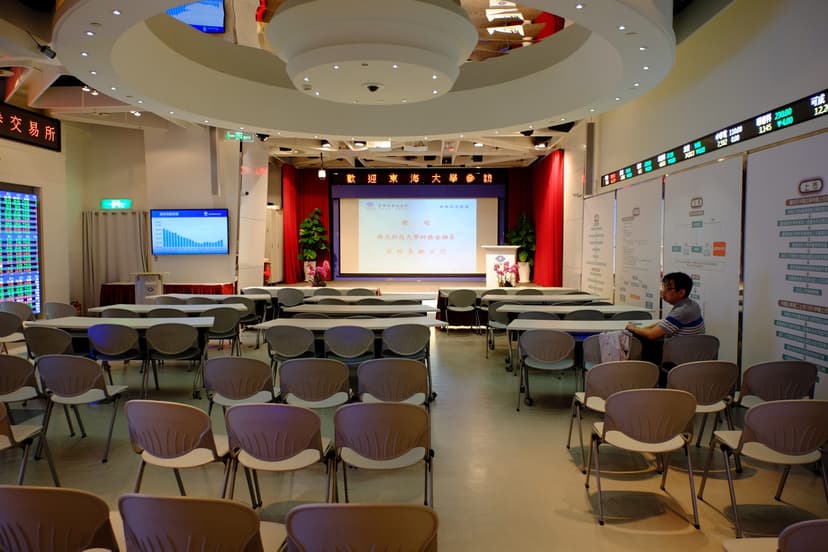An empty conference hall set out with chairs and presentation screens