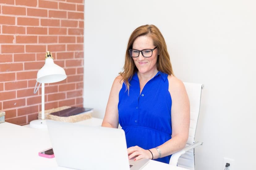 A person working at a laptop in a bright office