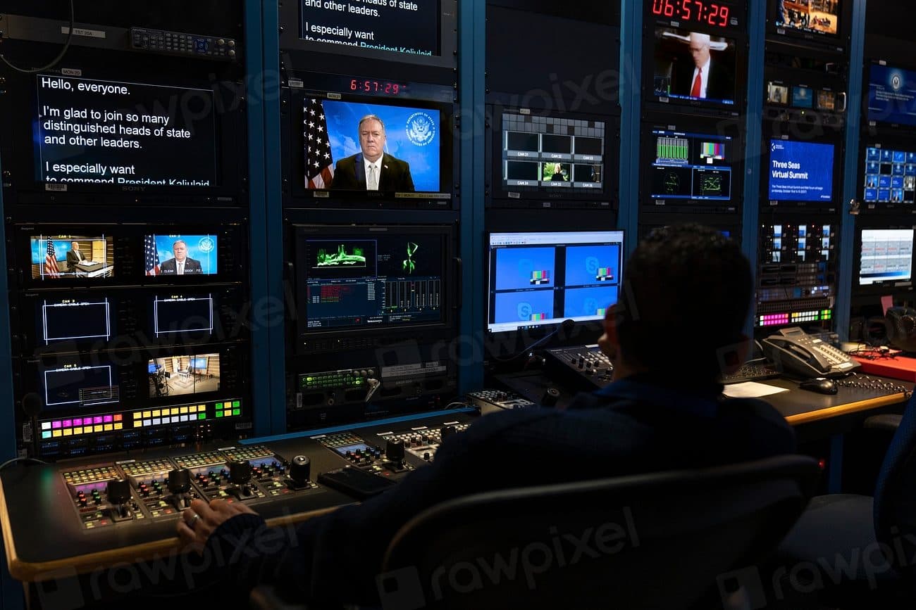 A television broadcast control room lined with monitors