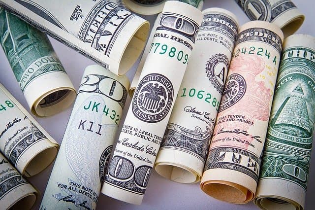 Rolled United States banknotes stood on end