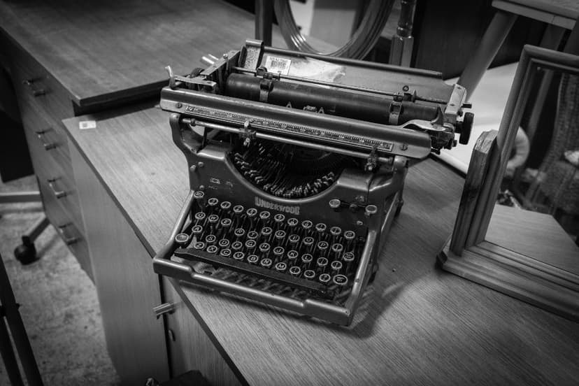 A black and white photograph of a manual typewriter