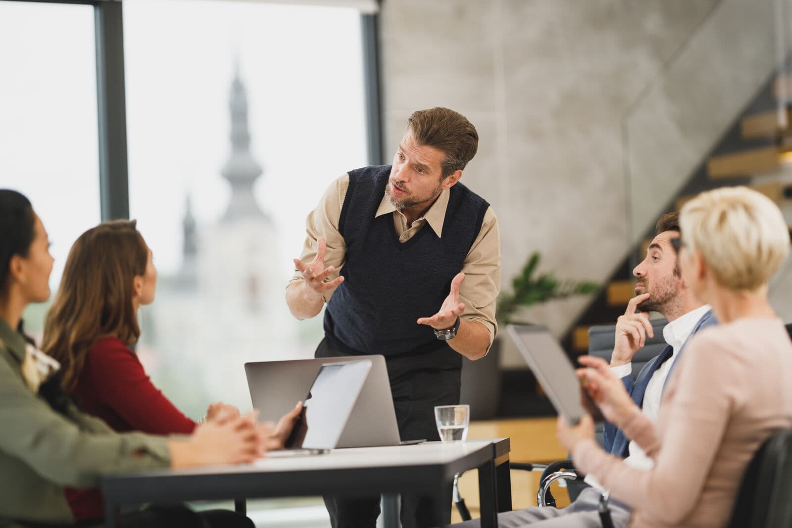 Four people talking around a table in a meeting room