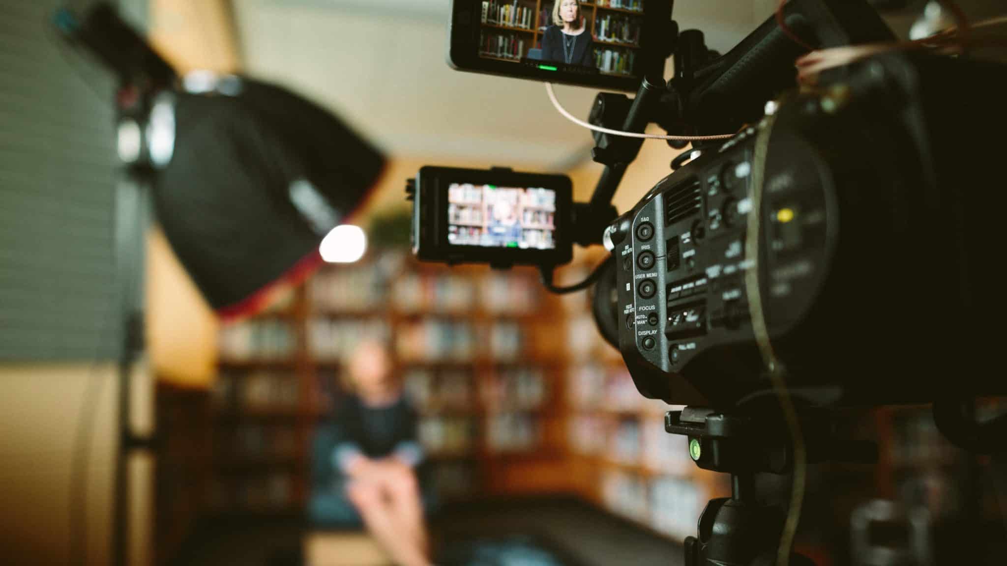 A video camera and lighting set up for an interview in a library