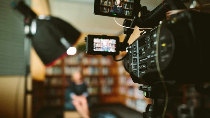 A video camera and lighting set up for an interview in a library