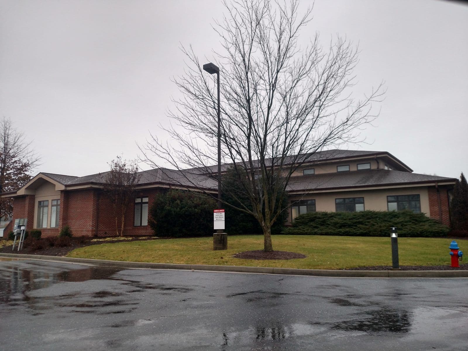 A single storey brick clinic building on a winter morning